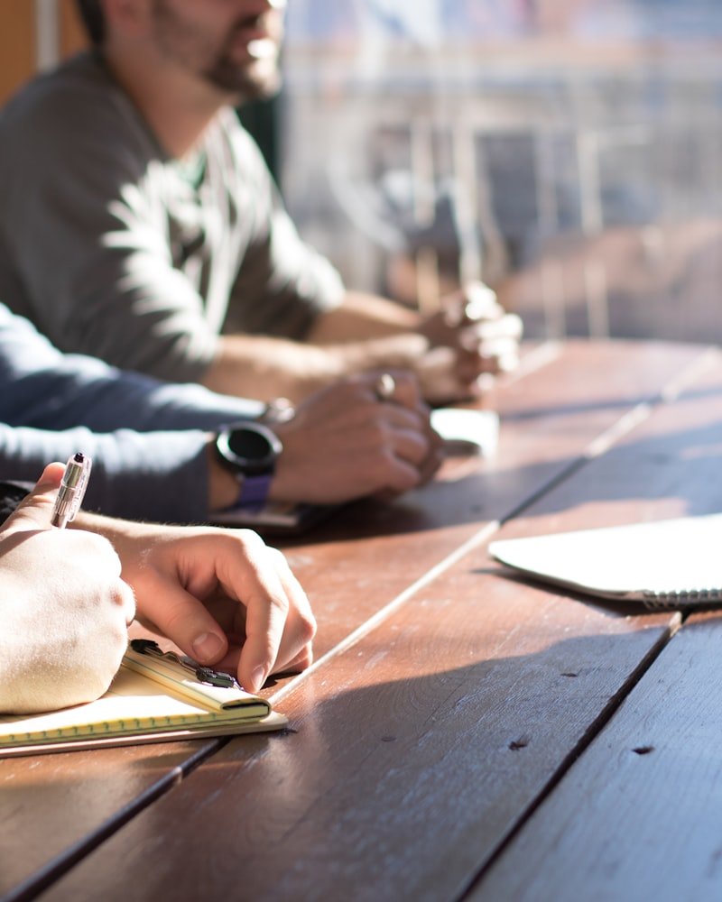 Deal team reviewing financials around a boardroom table